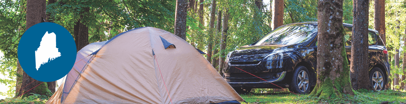 Car next to a tent in the woods