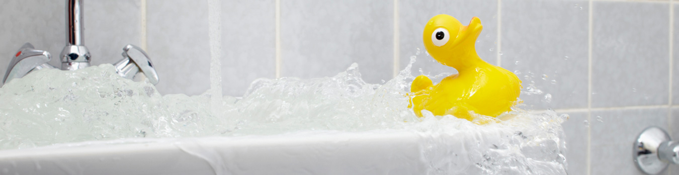 overflowing bathtub with rubber duck toy