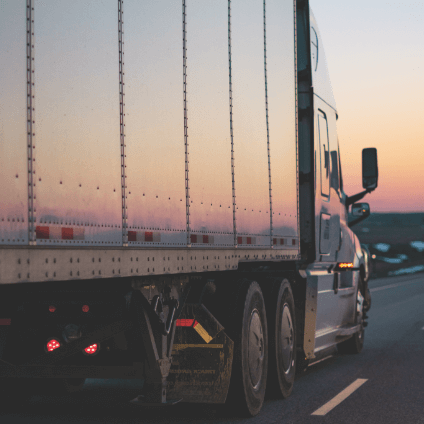 Tractor trailer on the highway at dusk