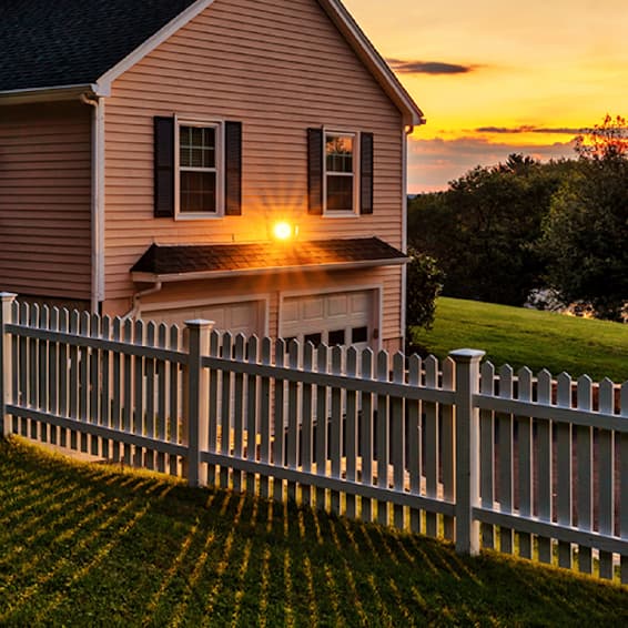 House with fence at sunset